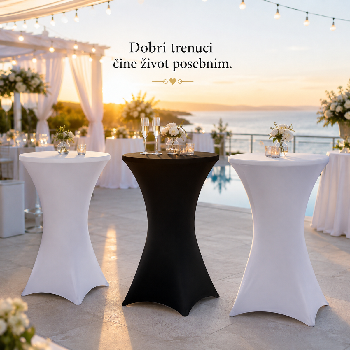Three high bar stools covered in white and black stretch table covers are arranged on an outdoor terrace at sunset, with champagne flutes on the center stool and decorative flowers. Text in the upper center reads 'Dobri trenuci Čhe ďvivot posebnim.